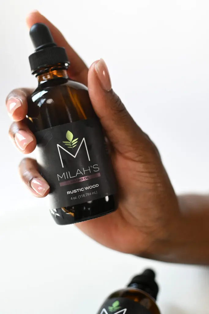 A person holding a bottle of milah 's cbd oil.